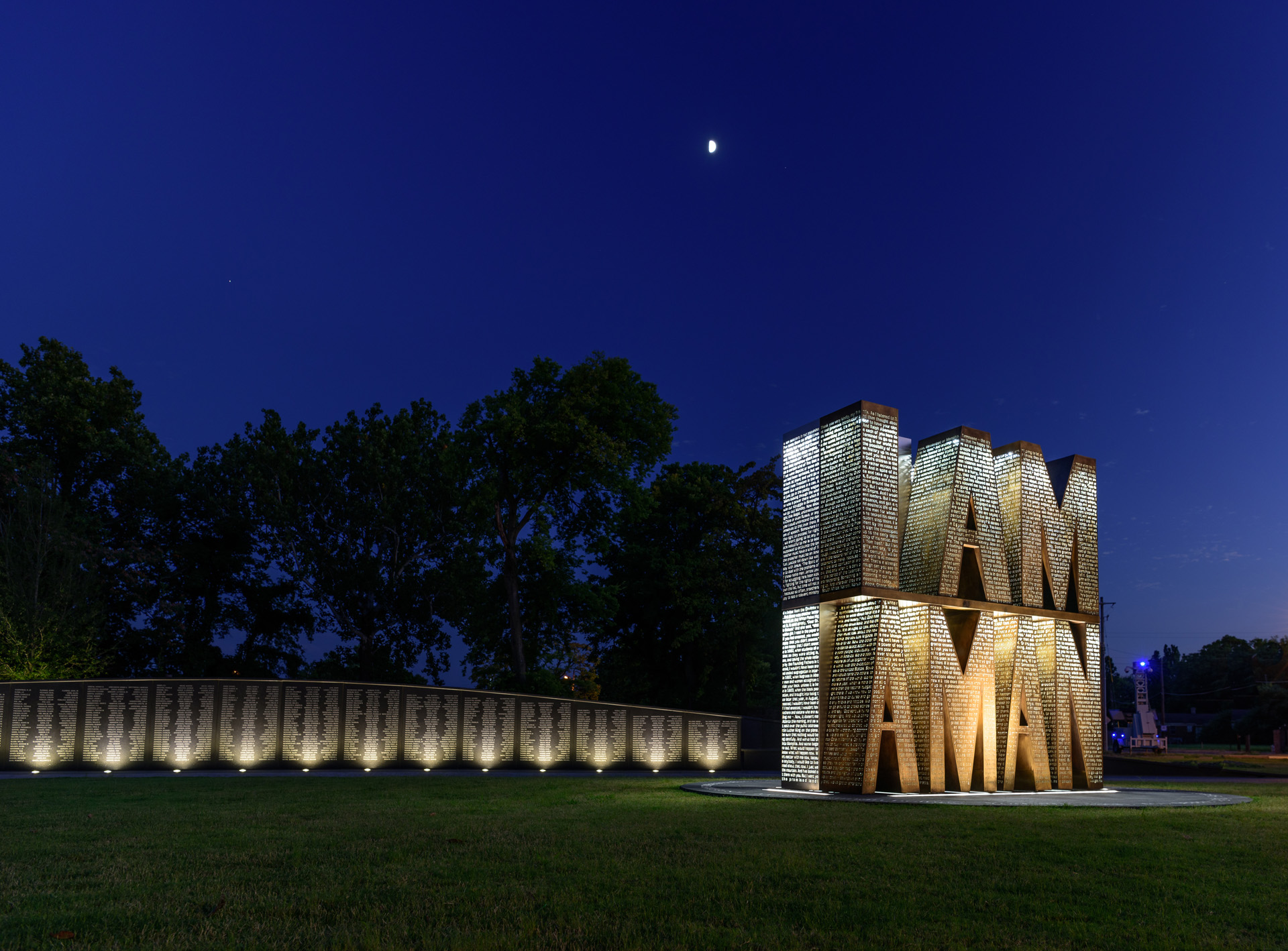 Photo at night time depicting large sculpture text that reads I Am A Man