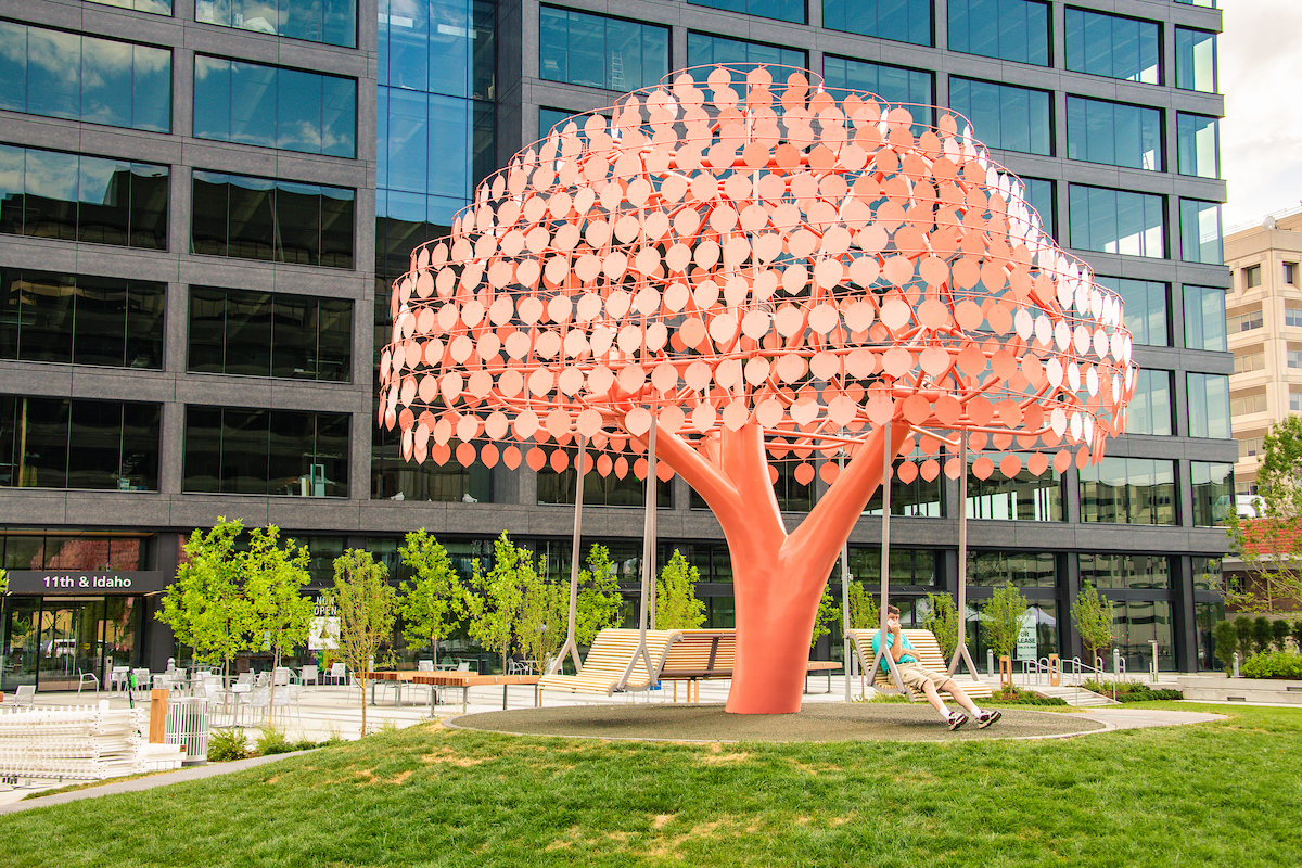 Sculpture of an orange tree in an outdoor plaza